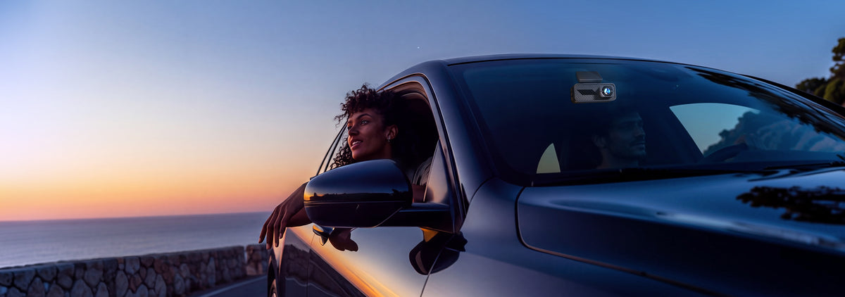 Pelsee S1 Pro front and rear dash cam mounted on a car windshield at sunset